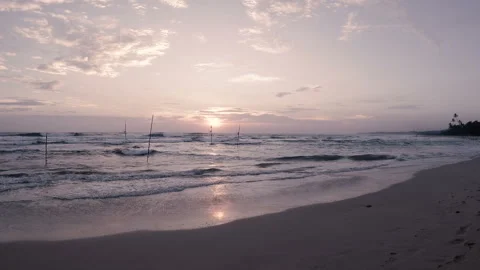 Waves of the Indian ocean at sunset on a deserted sandy beach Stock-Footage 86695033