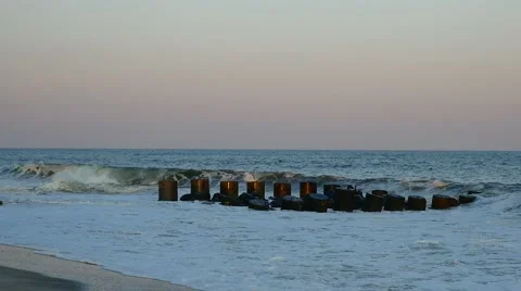Waves on jetty at sunset 動画素材 52488770