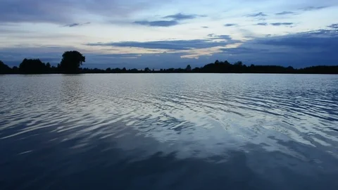 Waves on the lake and evening clouds after sunset Stock Footage 100302349