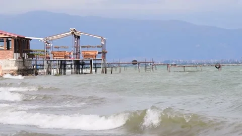 Waves from the lake hit the pier. Stock Footage 163913856