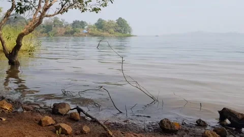 Waves on the lake side. Pan shot gently moving from the waves to the sky Stock-Footage 154369882