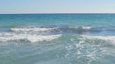 Waves landing on coast. Clear blue water. Slow motion Stock Footage 82210189