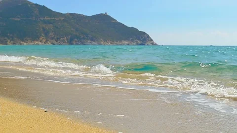 Waves landing on sandy beach. Clear blue water. Slow motion. Stock Footage 81767922