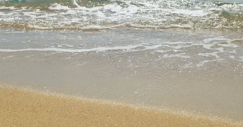 Waves landing on sandy beach. Clear blue water Stock Footage 82203564