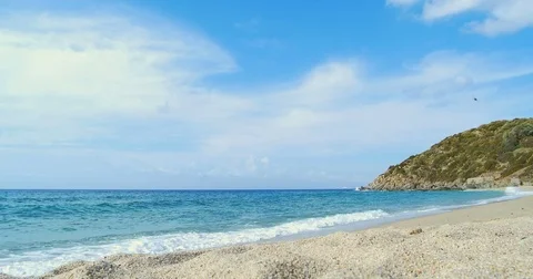 Waves landing on sandy beach. Clear blue water Video stock 82407219