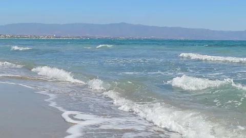 Waves landing on sandy beach. Clear blue water. Slow motion Stock Footage 82538462