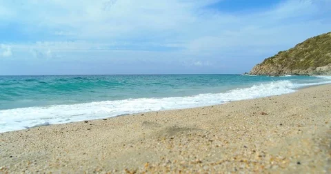 Waves landing on sandy beach. Clear blue water Stock Footage 82614479