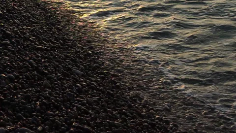 Waves Lap at Backlit Stones in slow motion Vidéo 141381086