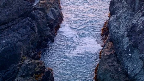 Waves lap between rocks at sunset from cliff Oregon Coast Stock Footage 81948802