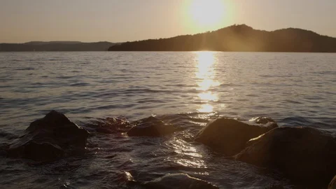 Waves Lap Gently Against Rocks In A Lake Stock Footage 87396982