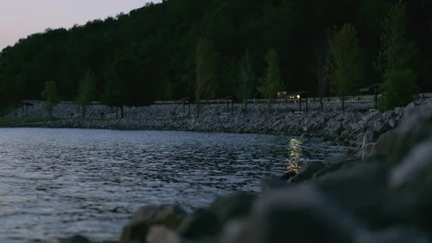 Waves Lap Gently Against Rocks In A Lake Stock Footage 87397133