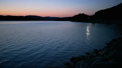 Waves Lap Gently Against Rocks In A Lake Stock Footage 87397251