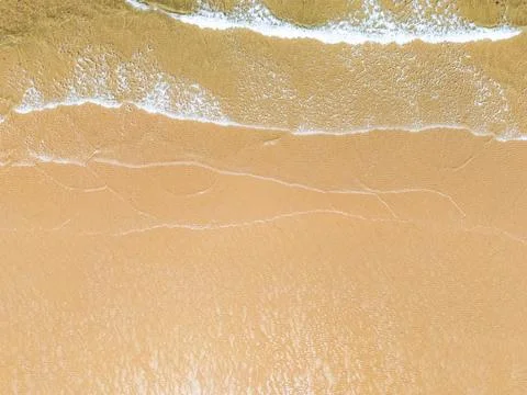 Waves lap on Holkham beach Stock Photos