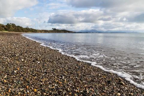 Waves lap up on Llanbedrog beach Stock Photos