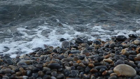 Waves Lap at stone sea shore in slow motion Vidéo 141381445