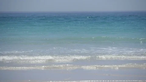 Waves lapping against a brilliant white sandy beach south of Cape Town Stock Footage 74730049