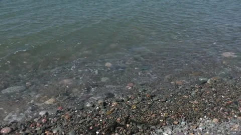 Waves lapping against pebbles Stock Footage 54089479