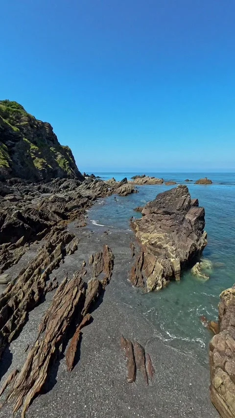 Waves lapping against the rocks on the rocky shore Video stock 281107120