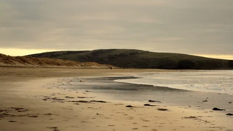 Waves lapping ashore on a remote sandy beach. Stock Footage 88341810