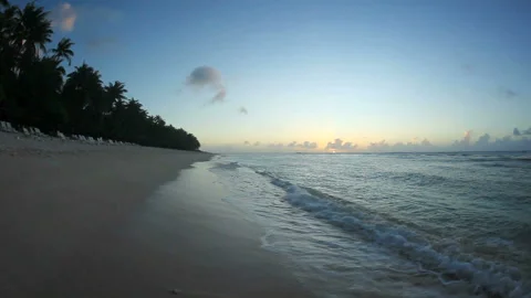 Waves Lapping at the Beach and the Sunset Stock Footage 324922625