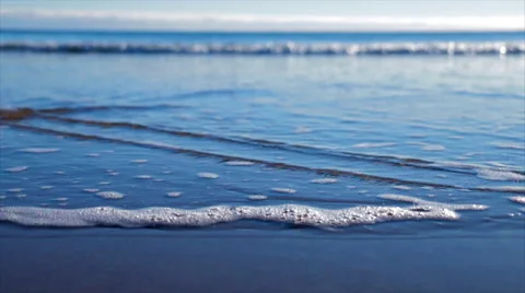 Waves lapping on beach with bubbles, close up Stock-Footage 60951085