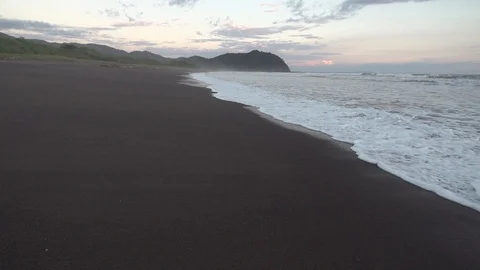 Waves Lapping at Black Sand Beach Shore Slow Motion Stock Footage 87723857