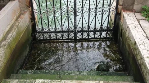 Waves lapping flooded metal gate and stairs Venice, Italy Video stock 332305558