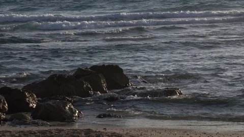 Waves Lapping Over Rocks on Beach Stock Footage