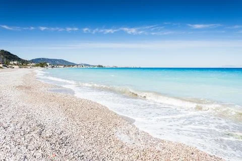 Waves lapping on the pebbles of Ixia beach Stock Photos