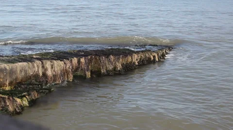 Waves lapping on a rock slipway Stock Footage 35245710