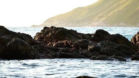 The waves lapping rocks  in the sea in the summer season at Andaman Sea or Pa Stock Footage 81345500