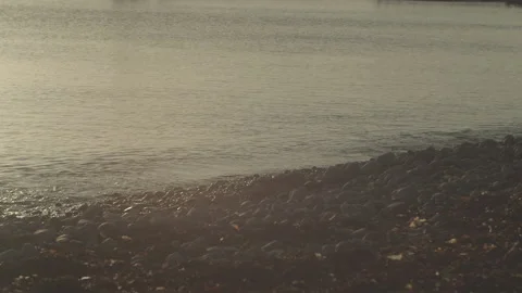 Waves Lapping Rocky Shore With Winter Afternoon Sun Stock Footage 149827801