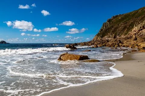 Waves lapping the sandy beach, at Porth Nanven in Cornwall Stock Photos