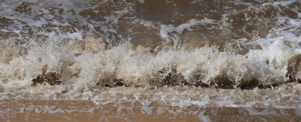 Waves lapping at seaside steps Stock Photos