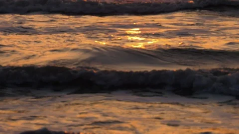 Waves lapping in shallow water at sunrise Stock Footage 93240784