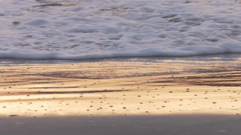 Waves lapping in shallow water at sunrise Stock Footage 93407992