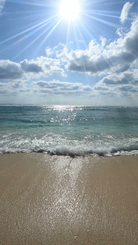 Waves Lapping at the Shore and Rays of Sunlight Video stock 324917641