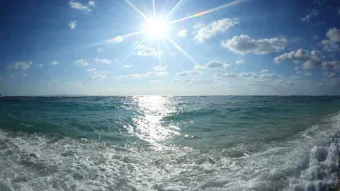 Waves Lapping at the Shore and Rays of Sunlight Video stock 324917726