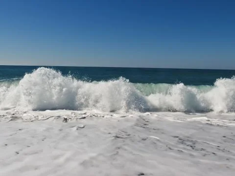 Waves lapping on the shore Stock Photos