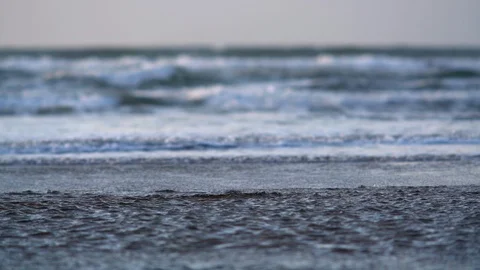 Waves lapping the shore at sunset. Stock Footage 88373586