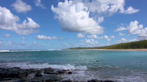 Waves lapping at Volcanic Rock on a Tropical Beach Stock Footage 138454283