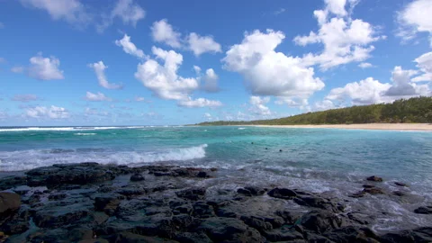 Waves lapping at Volcanic Rock on a Tropical Beach Video stock 138455077
