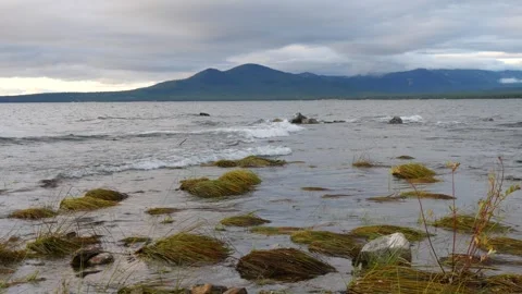 The waves of a large lake slowly roll onto the shore. Stock Footage 285381107