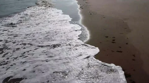 Waves lashing against the sandy beach, sun glistening, 4K" Stock Footage 212161674