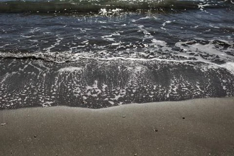 Waves, light and sand texture in the morning 스톡 사진