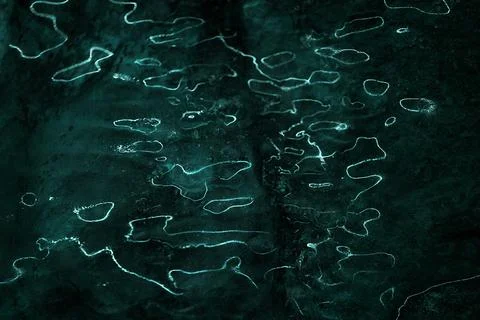 Waves of light reflections on dark background. Stock Photos