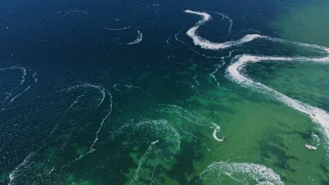 Waves made by boats create patterns on the water surface in the ocean Stock Footage 339652235