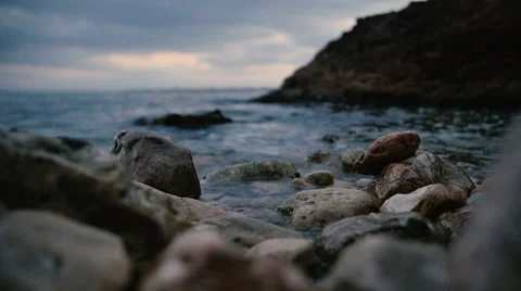 The waves of the mediterranean sea are rolled on a rocks Видео 64889762