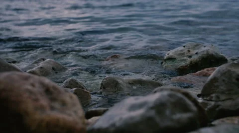 The waves of the mediterranean sea are rolled on a rocks Vídeos de archivo 64889865
