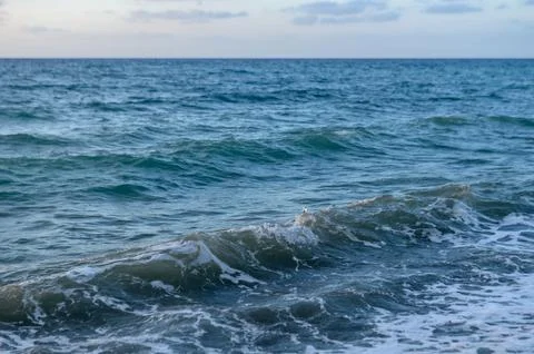 Waves of the Mediterranean sea in the rays of sunset 1 Stock Photos